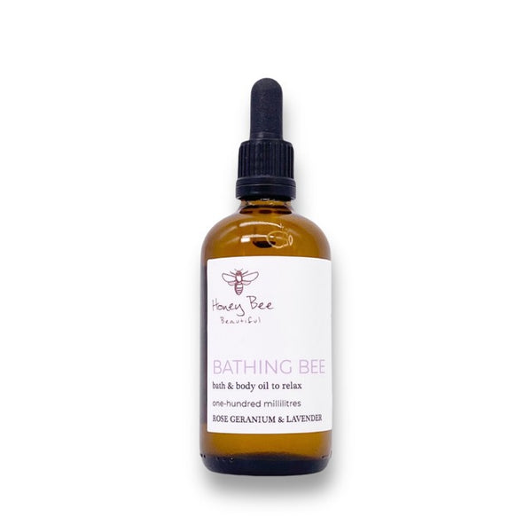 Golden honey-infused bath and body oil in glass bottle deeply moisturising and calming treatment for dry, sensitive or menopausal skin needing relaxation and softness.