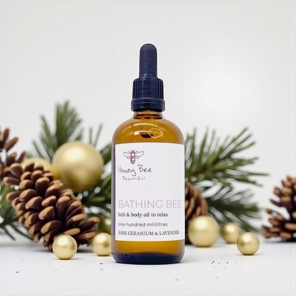 Golden honey-infused bath and body oil in glass bottle deeply moisturising and calming treatment for dry, sensitive or menopausal skin needing relaxation and softness.