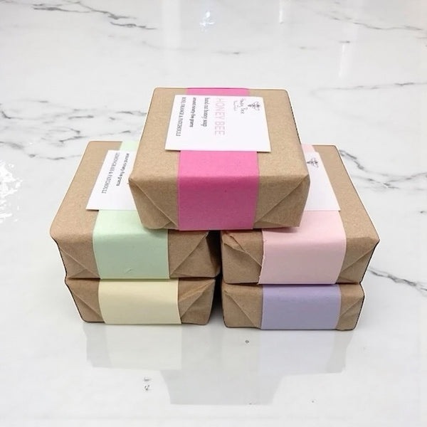 Selection of natural honey soaps in assorted scents gentle cleansing bars ideal for sensitive or menopausal skin, beautifully wrapped for gifting.