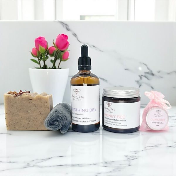 Elegant gift set with rose-infused raw honey skincare products presented in a box designed for dry or menopausal skin that needs calming nourishment and a spa-like ritual.