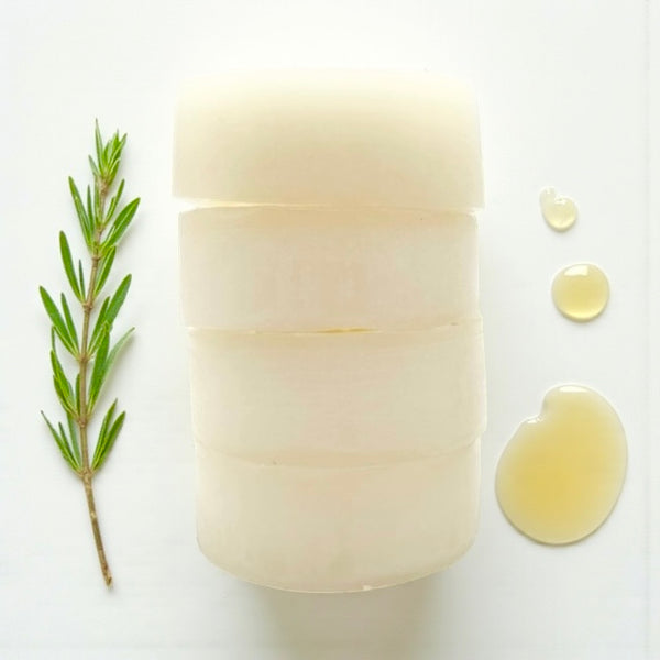 Stack of solid Glossy Bee conditioner bar enriched with raw honey and natural oils - nourishes, softens, and strengthens normal, oily, or dandruff-prone hair, leaving strands smooth, shiny, silky, and protected.