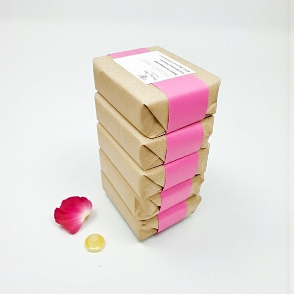Stack of gentle raw honey soap with rose, orange and patchouli, enriched with beeswax and plant oils, nourishing and soothing for dry, sensitive, or mature skin, with a subtle floral-citrus-woody fragrance.